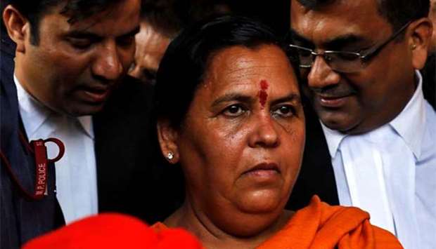 India's Water Resources Minister Uma Bharti, one of the accused charged over the 1992 Babri mosque demolition case, leaves after appearing in a court in Lucknow on Tuesday.