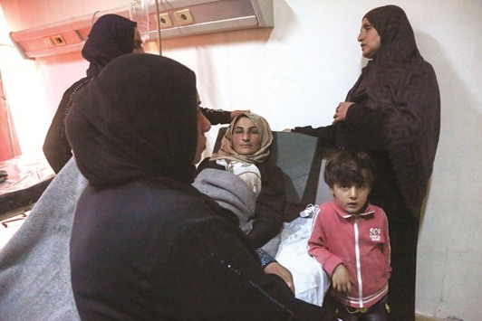 A family tends to an injured woman as she lies on a bed at a hospital in Syriau2019s northeastern city of Hassakeh, yesterday.