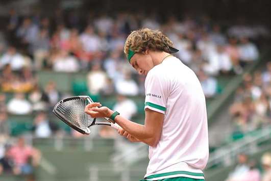Zverev looks at his damaged racquet during his match against Verdasco.
