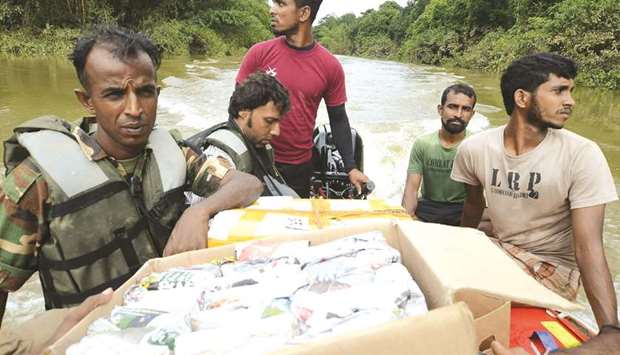 Army personnel distribute food to flood victims in Molkawa in the district of Kalutara yesterday.