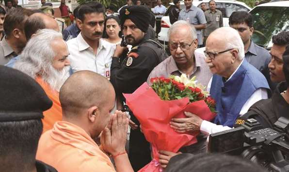Uttar Pradesh Chief Minister Yogi Adityanath and other leaders welcome BJP veteran L K Advani at a Lucknow guest house before the court ruling.
