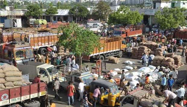 Indian traders and vendors negotiate prices of vegetables at a wholesale vegetable market in Hyderabad on Wednesday. India's economic growth slowed to 7.1% for the 2016-17 financial year,