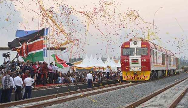 Kenyan President Uhuru Kenyatta flags off a cargo train as it leaves the container terminal at the port of the coastal town of Mombasa.