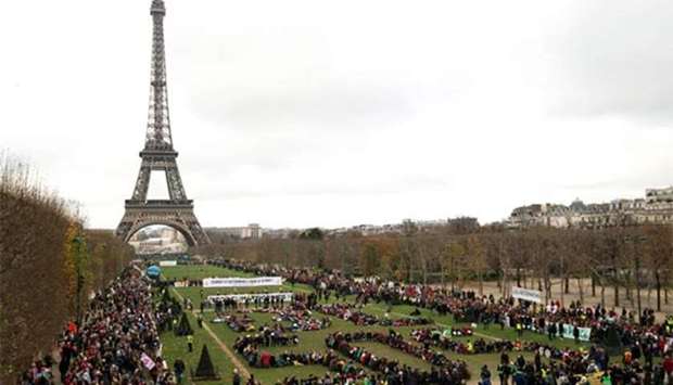 Non-governmental organisations gather to form a human chain near the Eiffel Tower in Paris on the sidelines of the COP21, the UN conference on global warming, in this December 12, 2015 file picture.