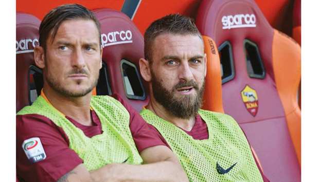 Romau2019s midfielder Daniele De Rossi (right) with Francesco Totti, who left the club on Sunday. (AFP)