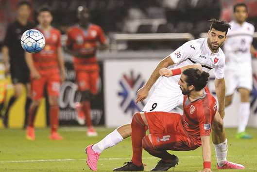 Lekhwiyau2019s Chico Flores (foreground) vies for the ball with Persepolisu2019 Mehdi Taremi during their AFC Champions League Round of 16 second leg match at Jassim Bin Hamad Stadium on Tuesday.  PICTURE: Noushad Thekkayil