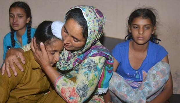 Wife of Indian army soldier Paramjeet Singh, Paramjeet Kaur cries and holds her son Sahildeep Singh as she is flanked by her daughters Simrandeep Kaur and Khushdeep Kaur at their residence in Vein Pein village, some 45 km from Amritsar. Paramjeet Singh was one of two Indian soldiers killed in Kashmir.