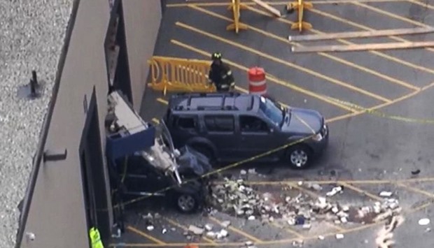 Television aerial footage showed that the Jeep smashed through the concrete wall of the warehouse, where several hundred people had gathered for a weekly auction.