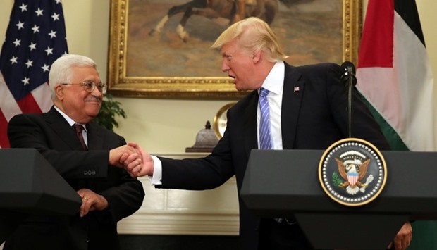 US President Donald Trump shakes hands with Palestinian President Mahmoud Abbas as they deliver a statement at the White House in Washington D.C.