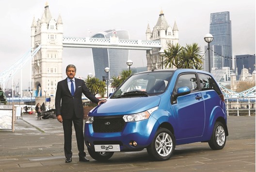 Anand Mahindra, chairman and managing director of Mahindra Group, poses with an e2o electric car during its launch in London. The Indian firm has stopped selling electric cars in the United Kingdom due to weak sales and is winding up sales operations there, according to a document seen by Reuters, in a new setback to the Indian automakeru2019s global ambitions.