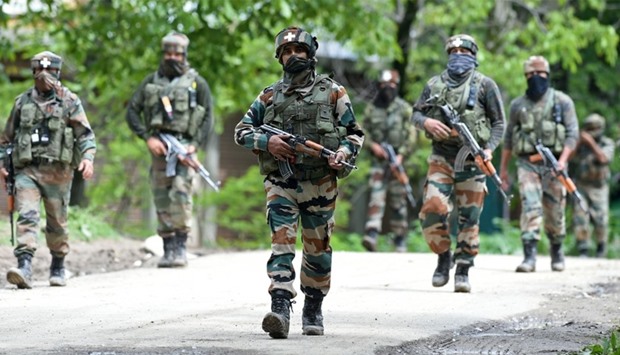 Indian army soldiers conduct a patrol in Shopian