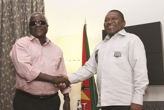This file photo taken on February 7, 2015 in Maputo shows President Nyusi (right) with Dhlakama.