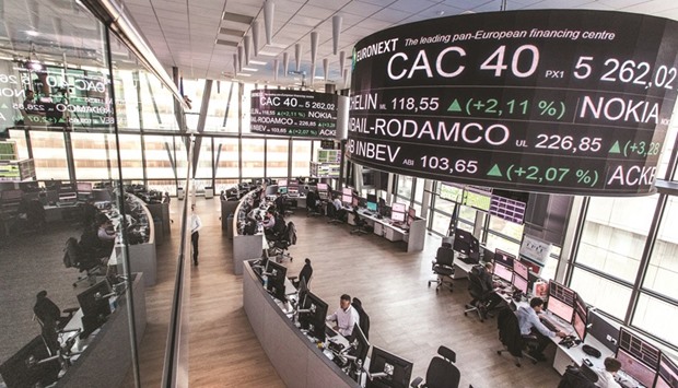 Stock prices information is displayed on a screen as it hangs above the Paris Stock Exchange, operated by Euronext, in La Defense business district in Paris (file). The French market outperformed its European counterparts yesterday, with the CAC 40 fizzing 1.4% higher to reach levels not seen since 2008.