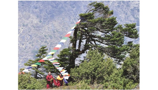 Nepalese monks hang prayer flags as they prepare for the cremation of Swiss climber Ueli Steck at Tengboche, some 300km north-east of Kathmandu.