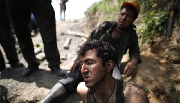 Coal miners react following an explosion in a mine in Azadshahr on Wednesday.