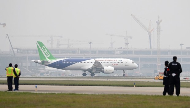 A Chinese C919 passenger jet taxis after landing on its first flight at Pudong International Airport in Shanghai.