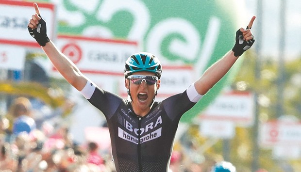 Austriau2019s Lukas Postlberger of team Bora celebrates as he crosses the finish line to win the first stage of the 100th Giro du2019Italia, Tour of Italy, from Alghero to Olbia in Sardinia. (AFP)