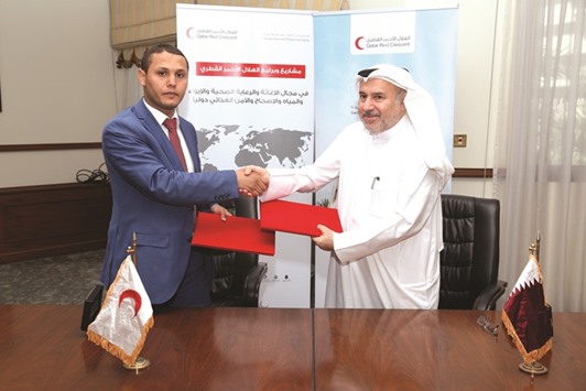 Salem Ramadan and Youssef Ahmed al-Hammadi at the signing ceremony.