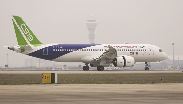 Chinau2019s home-grown C919 passenger jet lands during its first flight at Pudong International Airport in Shanghai yesterday.