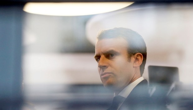 Emmanuel Macron, head of the political movement En Marche !, or Onwards !, and candidate for the 2017 presidential election, is pictured through a window of his hotel during a campaign visit in Rodez