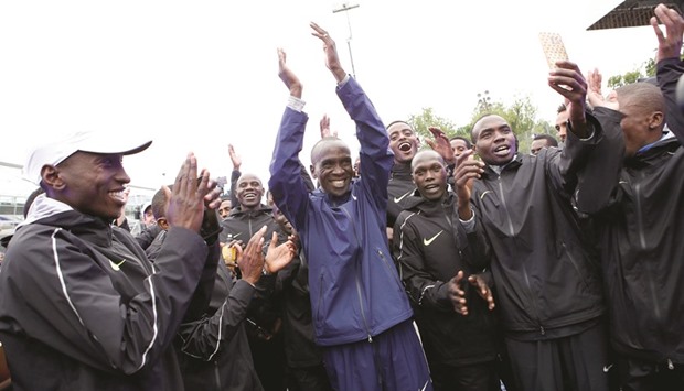Kenyan Eliud Kipchoge celebrates with pace-makers after an attempt to break the two-hour marathon barrier at the Monza circuit in Italy yesterday. (Reuters)