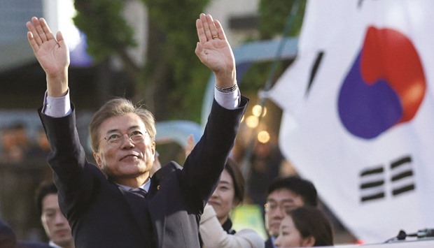 Moon Jae-in, presidential candidate of the Democratic Party of Korea, greets his supporters during his election campaign rally in Seoul.