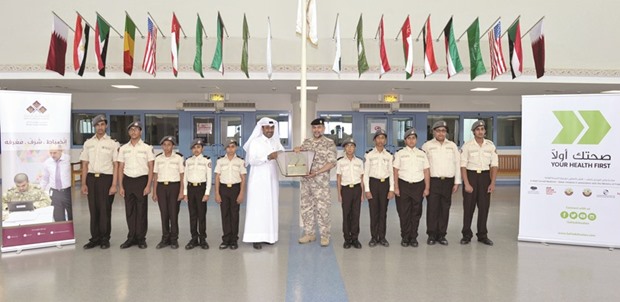 The winning school team receiving the trophy.