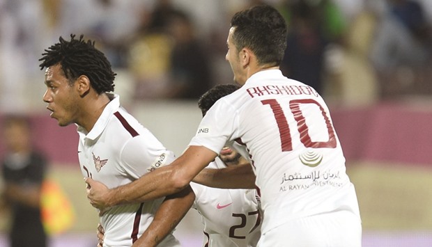 El Jaishu2019s Romarinho is congratulated by teammates after scoring against Umm Salal. At right, El Jaish coach Sabri Lamouchi reacts. PICTURES: Noushad Thekkayil