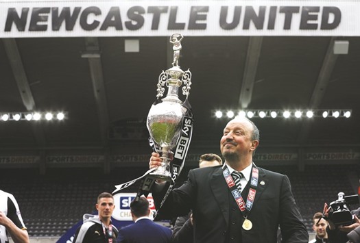 Newcastleu2019s manager Rafael Benitez celebrates winning the Championship with the trophy yesterday.