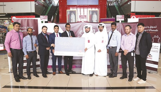 Officials of Quality Group and Qatar Charity at the launch of the charity loyalty card.
