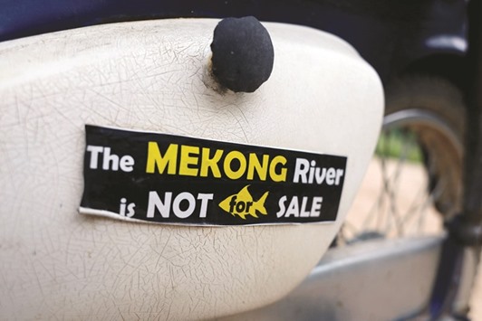 A sticker being displayed on the Thailand side of the Mekong River at the border between Laos and Thailand.