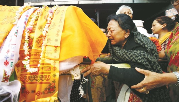 Wife of Nepali mountain climber Min Bahadur Sherchan mourns his death during a funeral procession after he died on Saturday at base camp in his attempt to become the oldest person to climb Mount Everest, in Kathmandu yesterday.