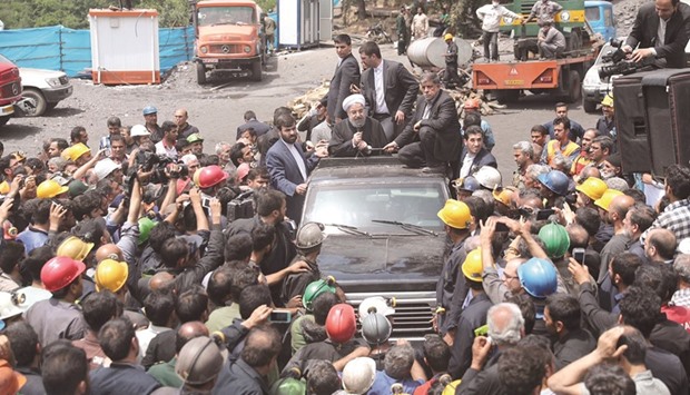 A handout picture provided by the office of Iranian President Hassan Rouhani yesterday shows him speaking with coal miners and rescue workers at the scene of a mine explosion in Azadshahr.