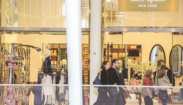 Shoppers pass in front of a Kate Spade & Co store inside the Oculus shopping mall in New York. The $18.50-a-share transaction represents a premium to Kate Spadeu2019s price when the Coach deal speculation first surfaced in December, but itu2019s well below the amount investors were betting on in more recent months.