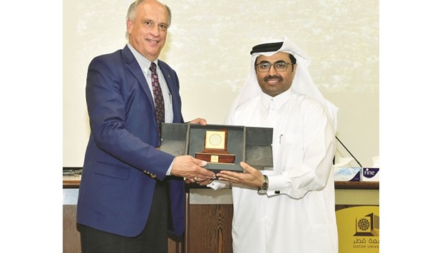 Dr Weichold receiving a commemorative plaque from HE Dr Mohamed bin Saleh al-Sada.
