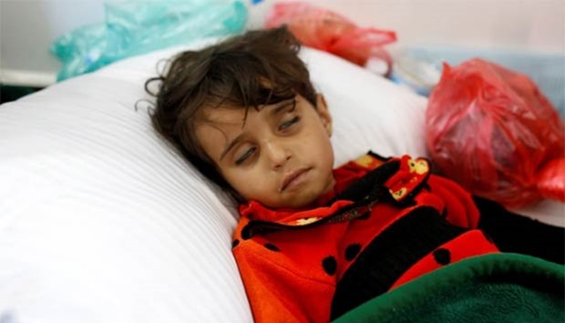 A girl infected with cholera lies on the ground at a hospital in Sanaa.