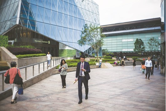 People walk outside the Hong Kong Stock Exchange building. While a lot of the crackdown-motivated selling has hit Chinau2019s mainland stock markets, Hong Kong-listed shares succumbed last week, with the H-share measure sliding the most this year.