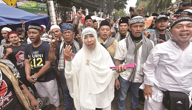 Indonesians demonstrate ahead of the blasphemy trial of Jakarta governor Basuki Tjahaja Purnama in Jakarta yesterday.
