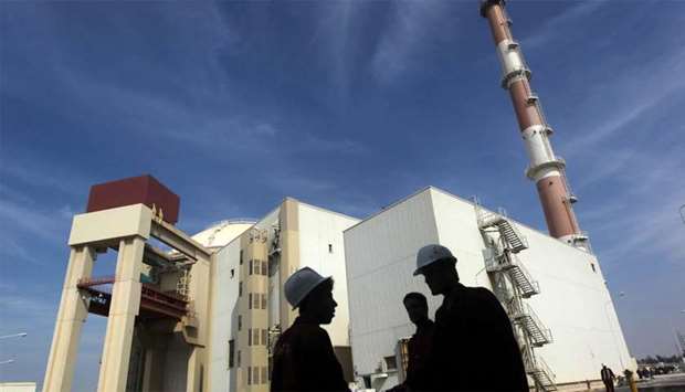 Iranian workers stand in front of Bushehr nuclear power plant 1,200 km south of Tehran