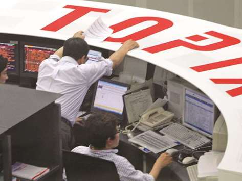 Traders at the Tokyo Stock Exchange. The index ended up 0.4 % at 22,497.18 points yesterday.
