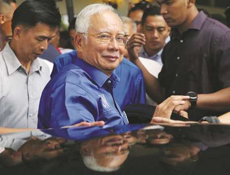 Malaysiau2019s outgoing Prime Minister Najib Razak leaves after a news conference following the general election in Kuala Lumpur.