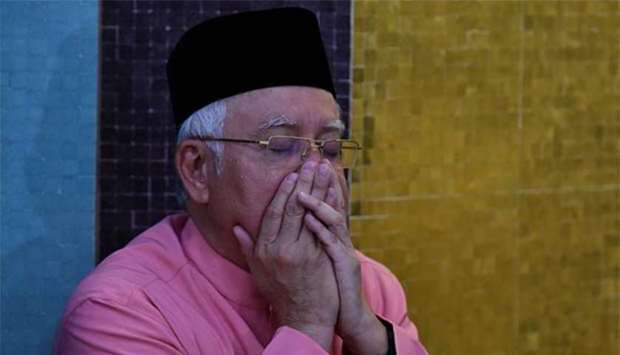 Malaysiau2019s former prime minister Najib Razak prays before he attends the United Malays National Organisation (Umno) 72nd anniversary celebrations in Kuala Lumpur on Friday.