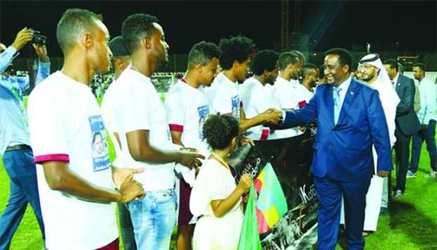 Ethiopian ambassador Metasebia Tadesse Woldegiorgis and Muaither Sports Club director Dr Mahmoud al-Mahmoud shaking hands with the players before the football final. PICTURES: Ram Chand