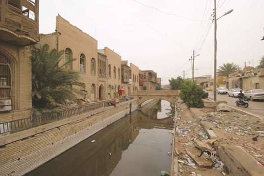 File photo shows waste dumped in the river near one of the ancient historic houses dating back to the time of Ottomans in the old downtown of Basra.