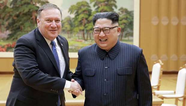 North Korean leader Kim Jong Un (R) and US Secretary of State Mike Pompeo (L) shaking hands
