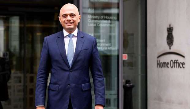Sajid Javid stands outside the Home Office after being named as Britain's Home Secretary, in London yesterday.
