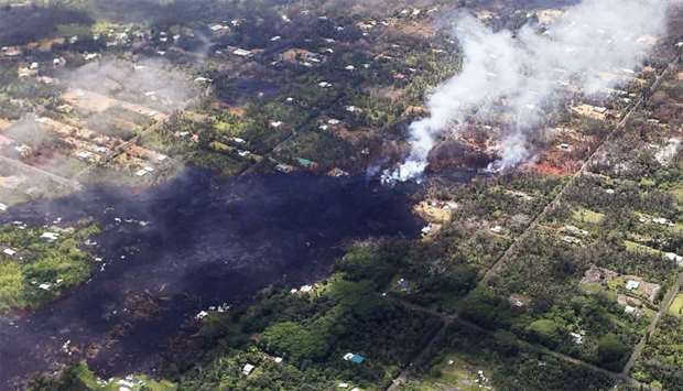 Smoke and volcanic gases rise as lava cools in the Leilani Estates neighborhood