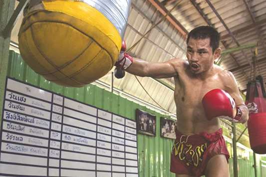 In this January 31, 2018 photo, the current World Boxing Council mini-flyweight champion Wanheng Menayothin punching a bag during a training session in Bangkok. (AFP)
