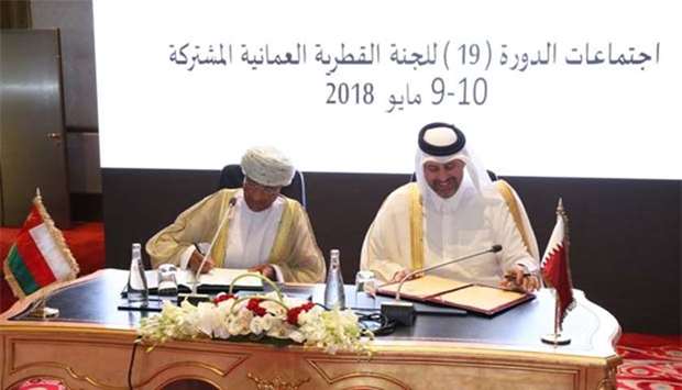 HE Sheikh Ahmed bin Jassim bin Mohamed al-Thani and Darwish bin Ismail bin Ali al-Bulushi signing the MoU in Doha.