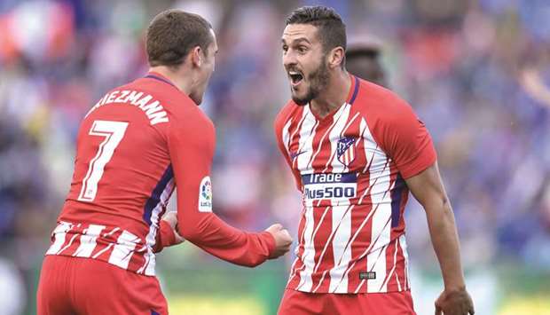 Atletico Madridu2019s Koke (right) celebrates with Antoine Griezmann after scoring a goal during the La Liga match against Getafe at the Coliseum Alfonso Perez stadium in Getafe, Spain. (AFP)